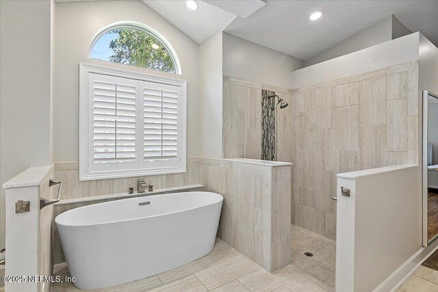 104 Haverhill Dr, Ponte Vedra Beach, FL 32082 - full bath featuring lofted ceiling, a soaking tub, a walk in shower, wainscoting, and recessed lighting
