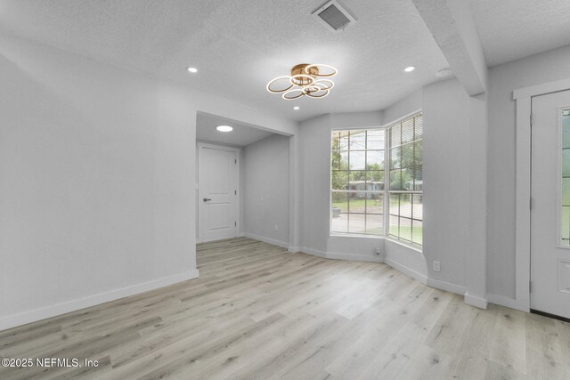 4903 Tennessee St, Jacksonville, FL 32208 - empty room featuring wood finished floors, a textured ceiling, a chandelier, and recessed lighting