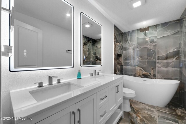 4903 Tennessee St, Jacksonville, FL 32208 - bathroom featuring marble tiled floors, a freestanding bath, double vanity, recessed lighting, and a shower