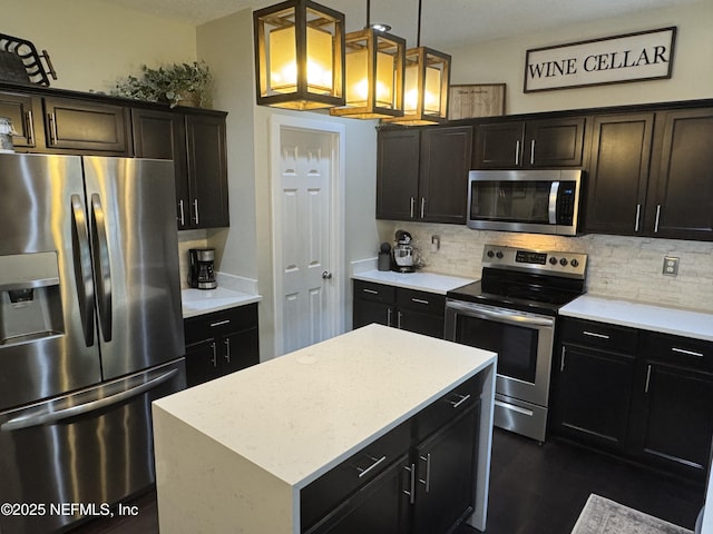 86163 Venetian Ave, Yulee, FL 32097 - kitchen featuring appliances with stainless steel finishes, backsplash, decorative light fixtures, and a center island