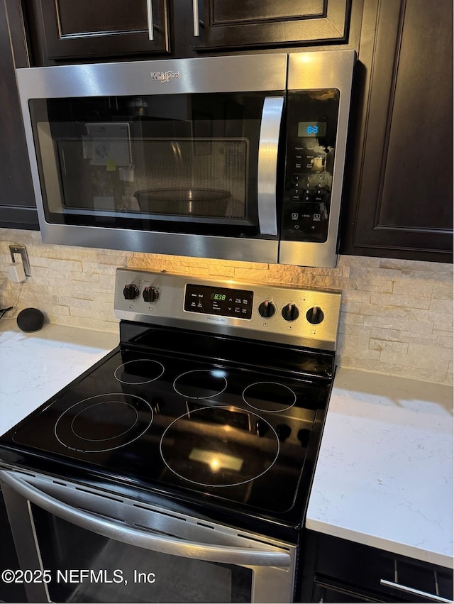 86163 Venetian Ave, Yulee, FL 32097 - kitchen view of stainless steel appliances, tasteful backsplash, dark brown cabinets, and light countertops