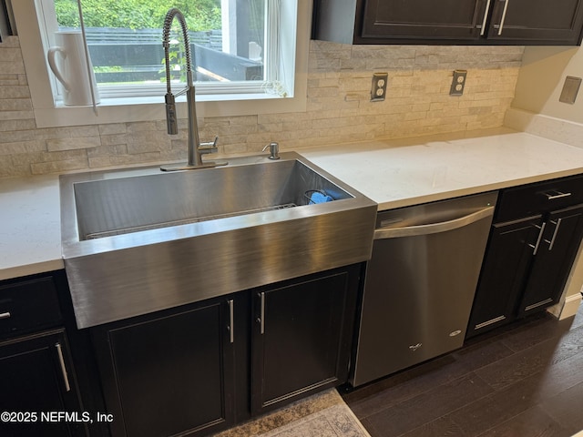 86163 Venetian Ave, Yulee, FL 32097 - kitchen with stainless steel dishwasher, tasteful backsplash, dark wood-style flooring, and dark cabinets