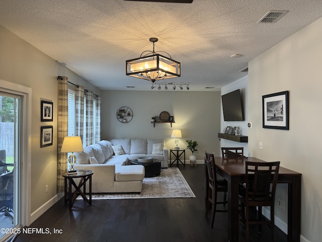 86163 Venetian Ave, Yulee, FL 32097 - living room featuring dark wood-style flooring, a textured ceiling, and a chandelier