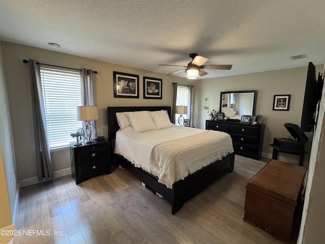 86163 Venetian Ave, Yulee, FL 32097 - bedroom featuring wood finished floors, a textured ceiling, and ceiling fan