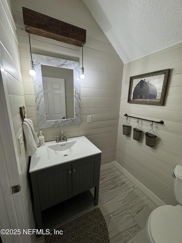 86163 Venetian Ave, Yulee, FL 32097 - bathroom featuring marble look tile flooring, vanity, and a textured ceiling