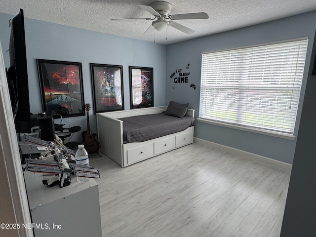 86163 Venetian Ave, Yulee, FL 32097 - bedroom featuring a textured ceiling, wood finished floors, and a ceiling fan