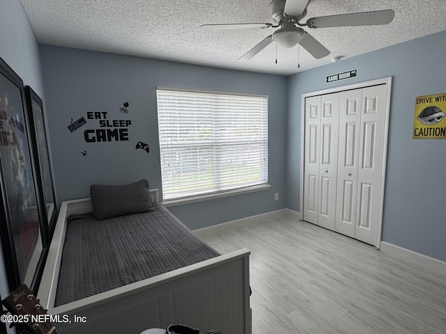 86163 Venetian Ave, Yulee, FL 32097 - bedroom with a textured ceiling, light wood-style floors, a closet, and a ceiling fan