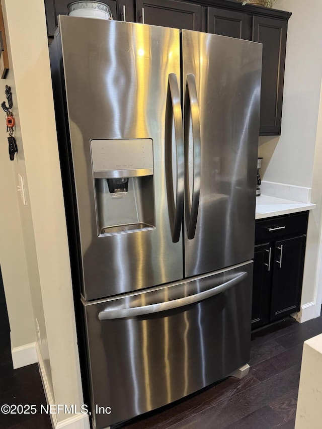 86163 Venetian Ave, Yulee, FL 32097 - kitchen view of stainless steel refrigerator with ice dispenser, dark wood-style floors, and light countertops
