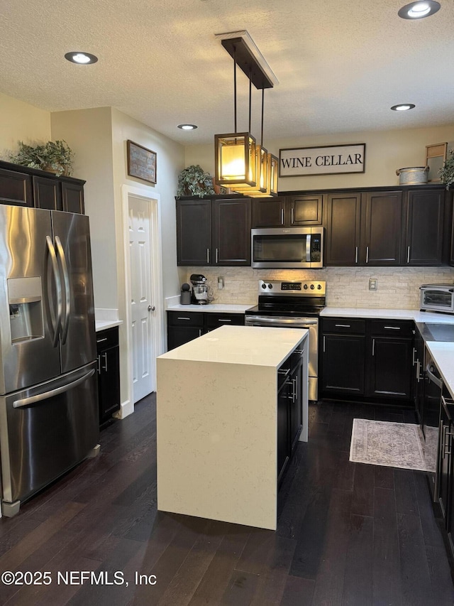 86163 Venetian Ave, Yulee, FL 32097 - kitchen featuring appliances with stainless steel finishes, dark wood finished floors, light countertops, backsplash, and recessed lighting