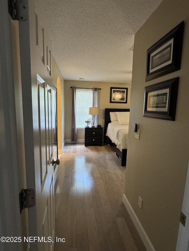 86163 Venetian Ave, Yulee, FL 32097 - bedroom featuring wood finished floors and a textured ceiling