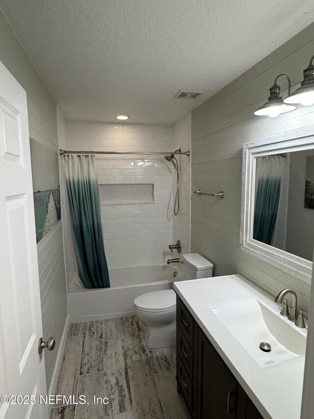 86163 Venetian Ave, Yulee, FL 32097 - full bath featuring a textured ceiling, vanity, shower / bathtub combination with curtain, and wood finished floors