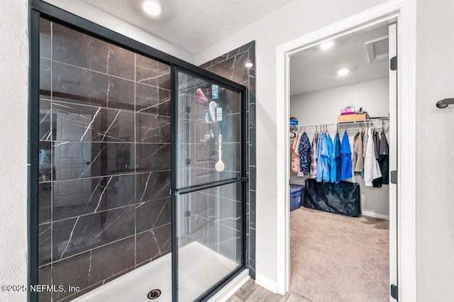 3283 Loblolly Pine Ct, Middleburg, FL 32068 - full bathroom with a shower stall, a textured ceiling, and a walk in closet