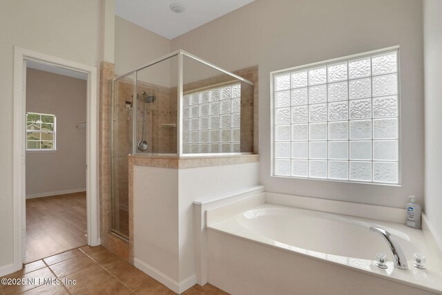 3559 Olympic Dr, Green Cove Springs, FL 32043 - bathroom with a garden tub, a shower stall, and tile patterned floors