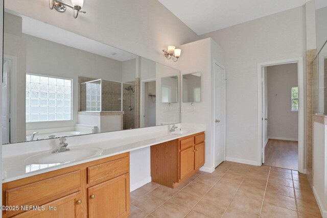 3559 Olympic Dr, Green Cove Springs, FL 32043 - bathroom featuring a stall shower, double vanity, tile patterned flooring, and a garden tub