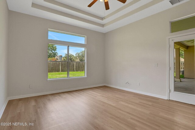 3559 Olympic Dr, Green Cove Springs, FL 32043 - unfurnished room with light wood-style flooring, a ceiling fan, and a raised ceiling