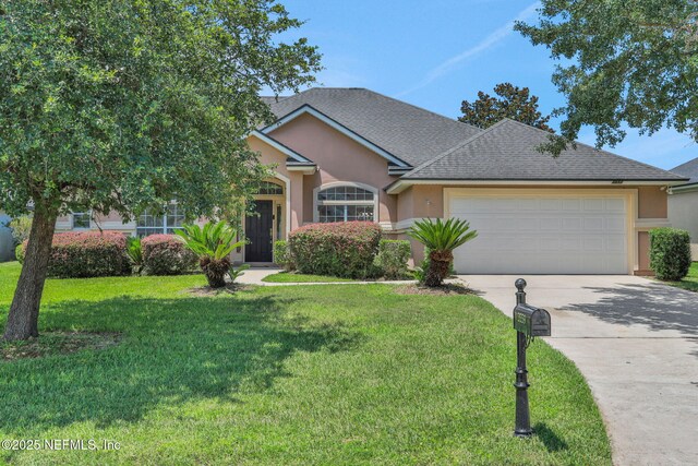 3559 Olympic Dr, Green Cove Springs, FL 32043 - view of front of house featuring stucco siding, concrete driveway, an attached garage, a front lawn, and roof with shingles
