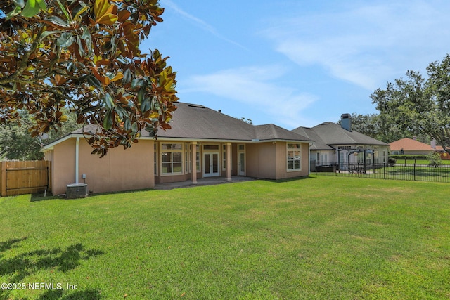 3559 Olympic Dr, Green Cove Springs, FL 32043 - back of property with french doors, a fenced backyard, and stucco siding