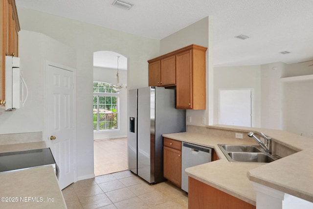 3559 Olympic Dr, Green Cove Springs, FL 32043 - kitchen featuring appliances with stainless steel finishes, a peninsula, light countertops, and a chandelier