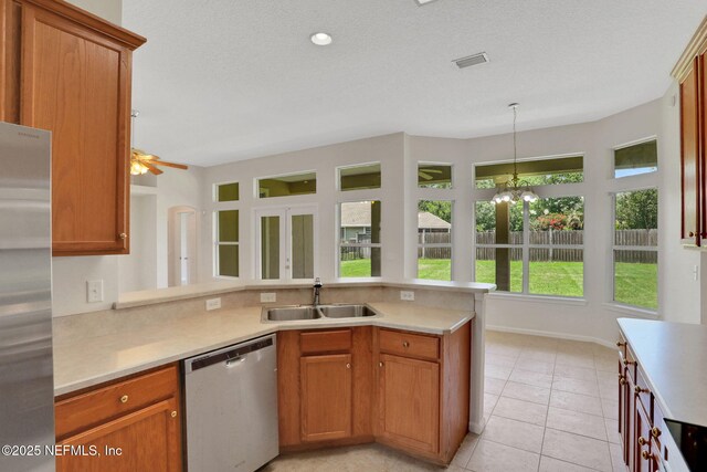 3559 Olympic Dr, Green Cove Springs, FL 32043 - kitchen featuring appliances with stainless steel finishes, a peninsula, light countertops, a ceiling fan, and pendant lighting