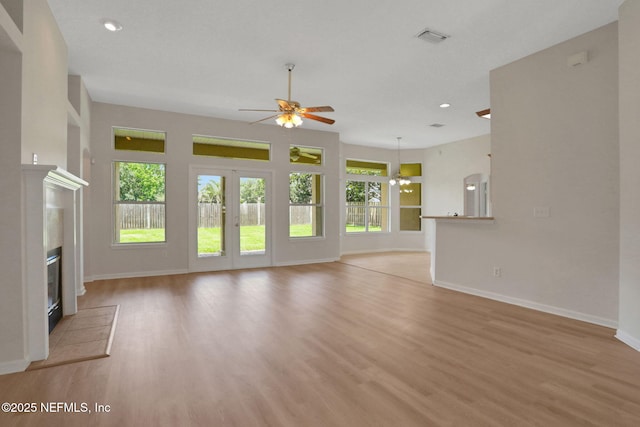 3559 Olympic Dr, Green Cove Springs, FL 32043 - unfurnished living room featuring ceiling fan, a tiled fireplace, light wood-style flooring, and recessed lighting