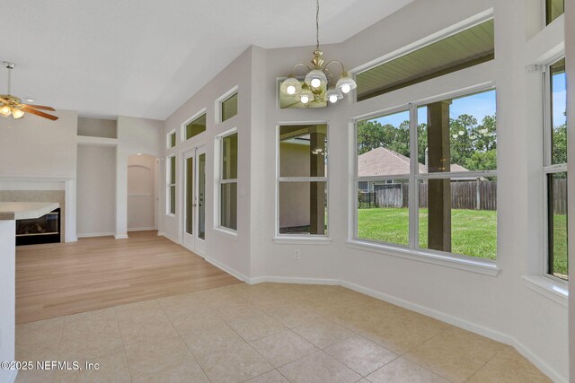 3559 Olympic Dr, Green Cove Springs, FL 32043 - unfurnished dining area featuring healthy amount of natural light, tile patterned floors, a glass covered fireplace, and a chandelier