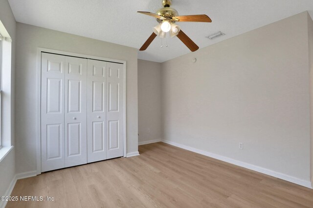 3559 Olympic Dr, Green Cove Springs, FL 32043 - unfurnished bedroom with light wood finished floors, a closet, and ceiling fan