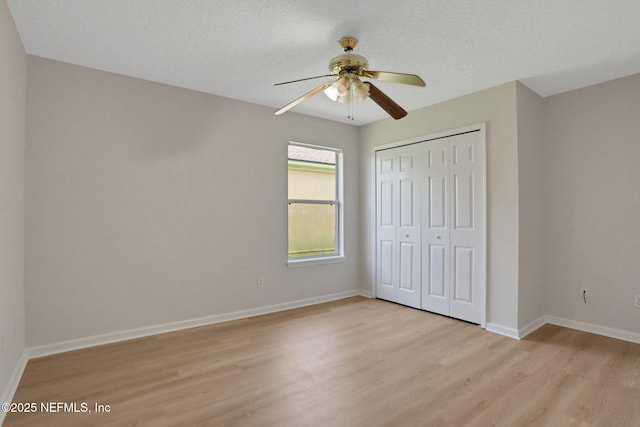 3559 Olympic Dr, Green Cove Springs, FL 32043 - unfurnished bedroom with light wood-type flooring, a closet, and a ceiling fan