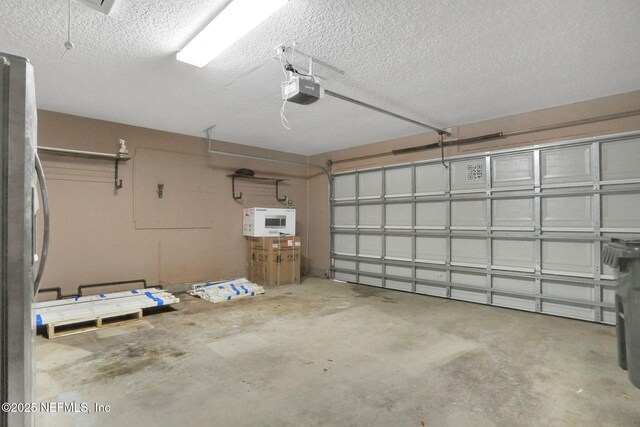 3559 Olympic Dr, Green Cove Springs, FL 32043 - garage with freestanding refrigerator and a garage door opener