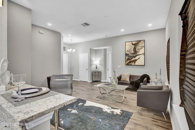 7442 Richardson Rd, Jacksonville, FL 32209 - living area with wood finished floors, recessed lighting, and a chandelier