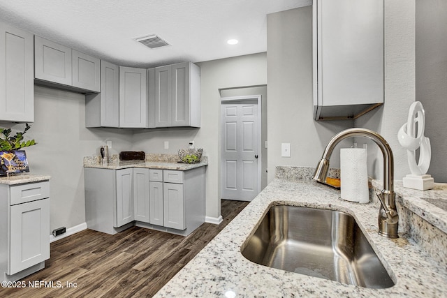 7442 Richardson Rd, Jacksonville, FL 32209 - kitchen featuring dark wood finished floors, light stone countertops, gray cabinetry, and recessed lighting