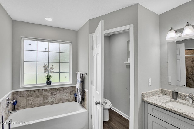 7442 Richardson Rd, Jacksonville, FL 32209 - full bathroom featuring a garden tub, vanity, plenty of natural light, and wood finished floors
