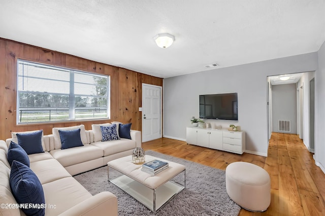 6317 Trout River Blvd, Jacksonville, FL 32219 - living area featuring light wood-style flooring and wood walls