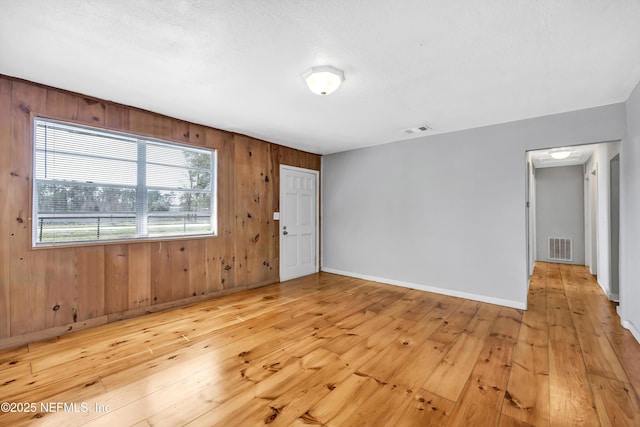 6317 Trout River Blvd, Jacksonville, FL 32219 - unfurnished room with light wood-style flooring and wood walls