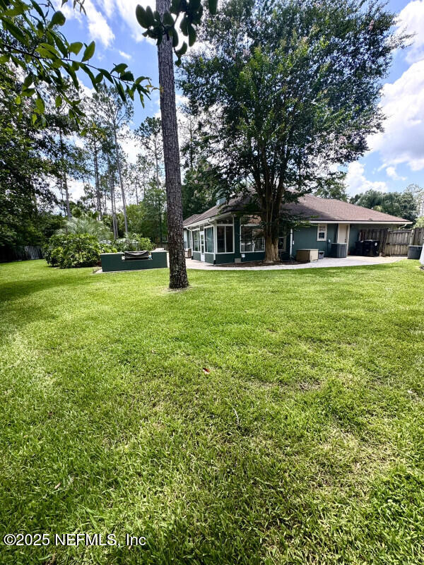 1703 Hunters Ridge Rd, Fleming Island, FL 32003 - view of green lawn with a patio