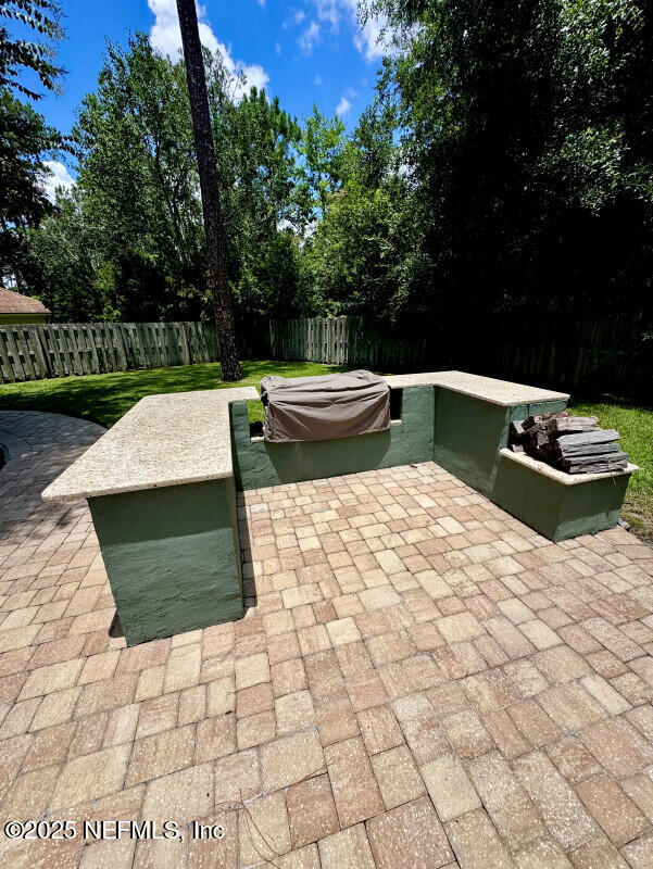 1703 Hunters Ridge Rd, Fleming Island, FL 32003 - fenced backyard featuring a patio