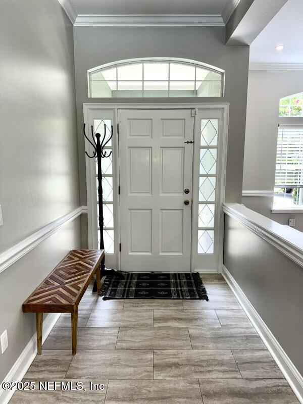 1703 Hunters Ridge Rd, Fleming Island, FL 32003 - foyer entrance featuring ornamental molding and wood finished floors