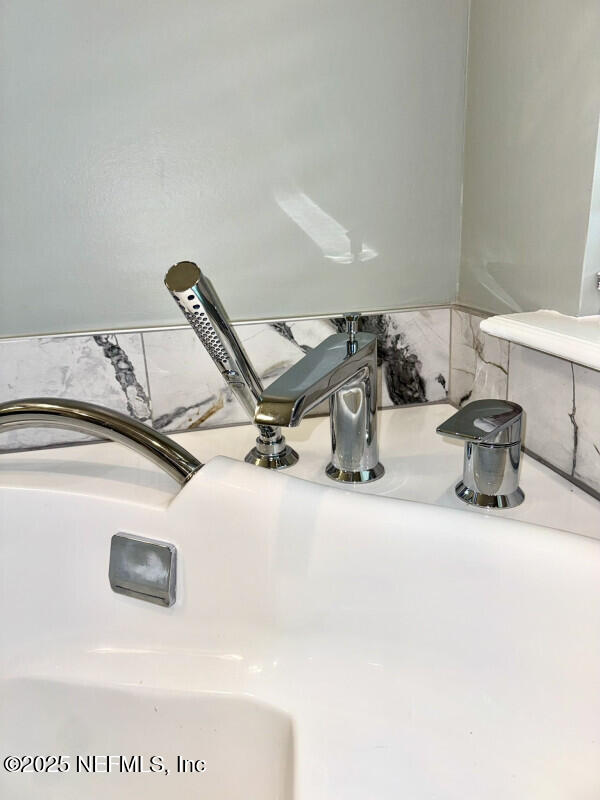 1703 Hunters Ridge Rd, Fleming Island, FL 32003 - bathroom view of a sink and decorative backsplash