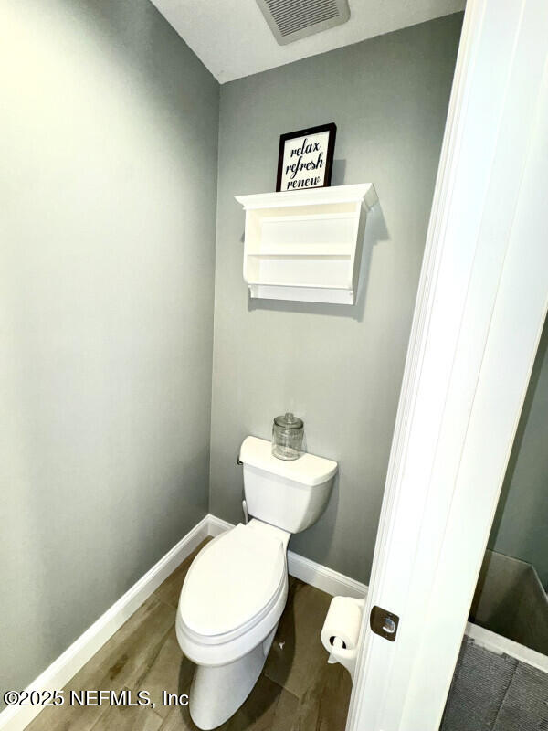 1703 Hunters Ridge Rd, Fleming Island, FL 32003 - bathroom featuring toilet and wood finished floors