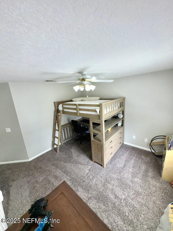 1703 Hunters Ridge Rd, Fleming Island, FL 32003 - unfurnished bedroom with carpet and a textured ceiling