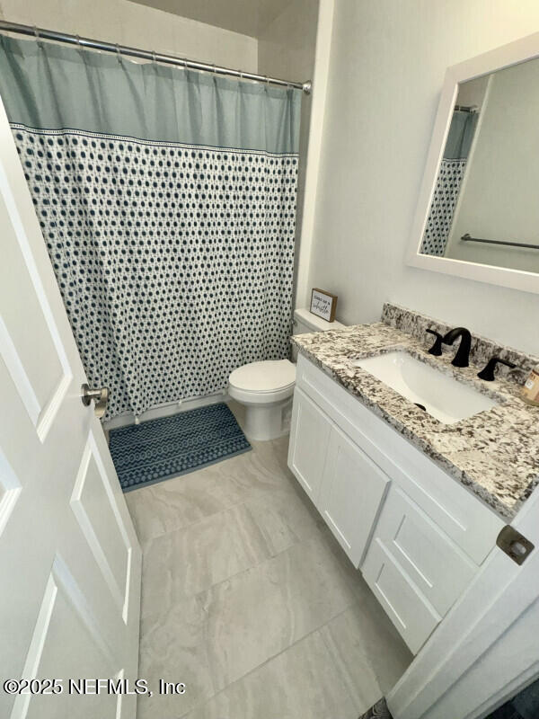 1703 Hunters Ridge Rd, Fleming Island, FL 32003 - full bathroom with vanity and a shower with shower curtain