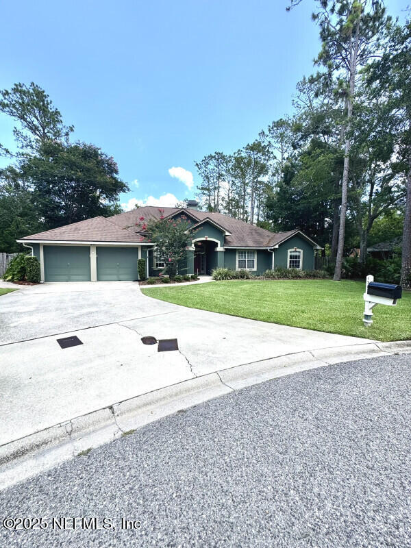 1703 Hunters Ridge Rd, Fleming Island, FL 32003 - single story home with driveway, a garage, and a front yard