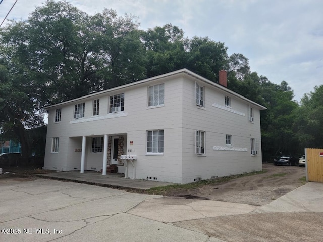 5718 Merrill Rd, Jacksonville, FL 32277 - view of front of house featuring a chimney, crawl space, a porch, and driveway