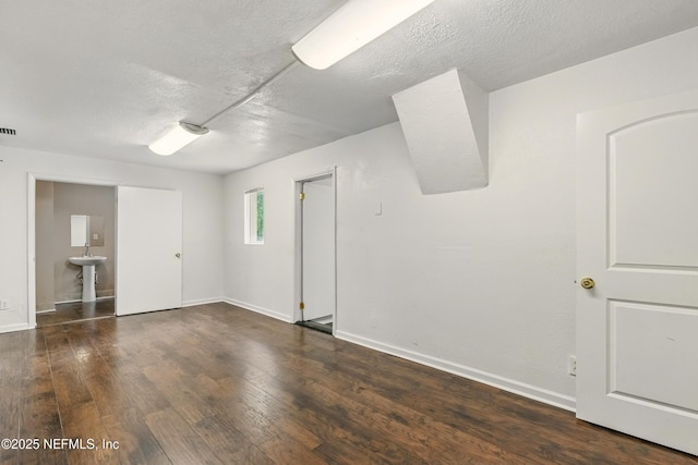 7120 Merrill Rd, Jacksonville, FL 32277 - empty room with wood finished floors and a textured ceiling