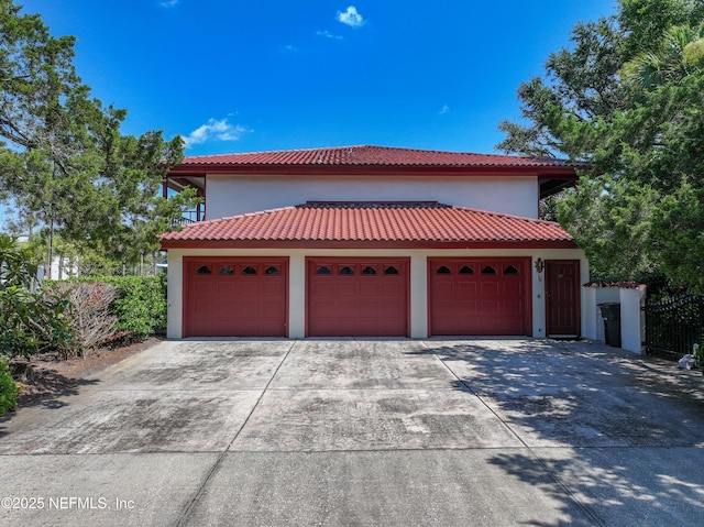 1313 E Coast Dr, Atlantic Beach, FL 32233 - view of front facade with driveway, stucco siding, a garage, and a tiled roof