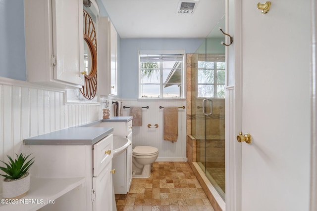 2910 Lake Shore Blvd, Jacksonville, FL 32210 - full bath featuring a shower stall, stone finish floors, vanity, and wainscoting