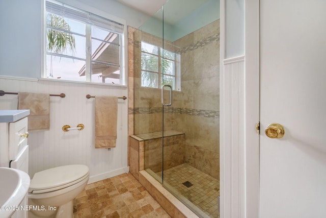 2910 Lake Shore Blvd, Jacksonville, FL 32210 - full bath featuring a stall shower, vanity, wainscoting, and stone finish flooring
