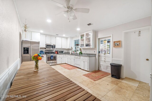2910 Lake Shore Blvd, Jacksonville, FL 32210 - kitchen with stainless steel appliances, white cabinetry, a ceiling fan, light tile patterned flooring, and recessed lighting