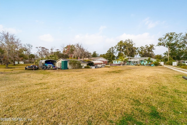 2910 Lake Shore Blvd, Jacksonville, FL 32210 - view of green lawn with a detached carport