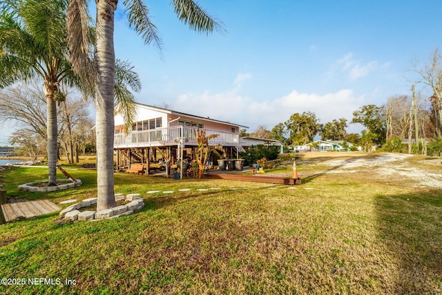 2910 Lake Shore Blvd, Jacksonville, FL 32210 - view of grassy yard featuring a deck, stairway, and driveway