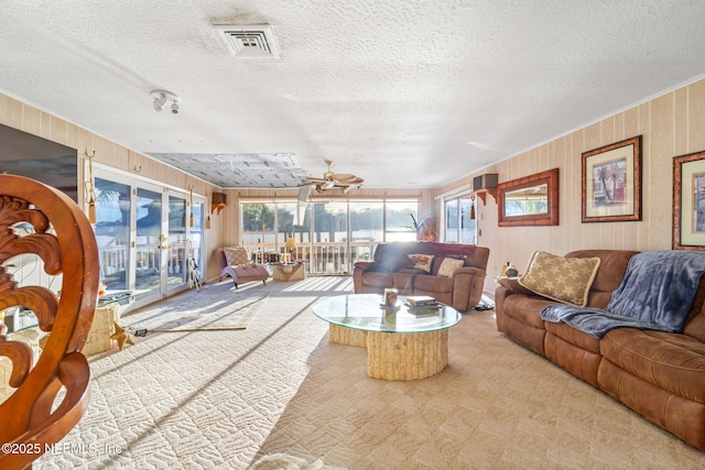 2910 Lake Shore Blvd, Jacksonville, FL 32210 - living area featuring carpet floors, a textured ceiling, ceiling fan, crown molding, and wood walls